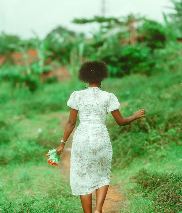 Woman performing a fluid, gentle movement in a calm environment.
